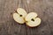 Slices apples on wooden surface