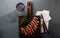 Slices of beef medium rare steak on wooden board, glass of red wine