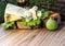 Slices of blue cheese on a green lettuce leaf with figs on a background of tree bark. A shot of alcohol