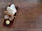 Slices of bread and butter on a wooden plate on a wooden serve table in a restaurant