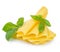 Slices of cheese with fresh basil leaves close-up isolated on white background.