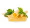 Slices of cheese with fresh basil leaves close-up isolated on a white background.