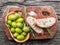 Slices of ciabatta with olives and spices on the serving wooden