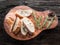 Slices of ciabatta with rosemary herb on the serving wooden tray