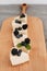 Slices of classic cheesecake decorated with berries on a wooden board