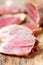 Slices of cured meet and pepper on table close up