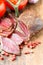 Slices of cured meet on wooden table close up