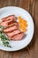 Slices of duck breast with fresh thyme