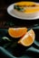Slices of fresh juicy orange on an emerald linen tablecloth