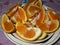 Slices fresh oranges pieces in a dish