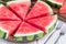 Slices of fresh seedless watermelon cut into triangle shape on wooden plate, horizontal