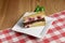 Slices of fruitcake. One piece of vanilla cake with dryed fruit served on a square plate over wooden background