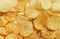 Slices Golden chips with stripes lying slides background texture. View from above