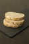 Slices of homemade multigrain bread on black slate board