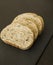 Slices of homemade multigrain bread on black slate board