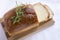 Slices of homemade white bread loaf on wood cutting board