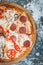 Slices of italian pizza on abstract dark background with wheat flour.