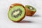 Slices of kiwi fruit on kiwi background.Fresh kiwis on wooden ground