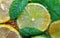 Slices of limes and lemons, leaves of mint and cane sugar