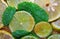 Slices of limes and lemons, leaves of mint and cane sugar