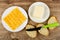 Slices of marble cheese in plate, butter in saucer, knife, slices of bread on table. Top view