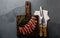 Slices of medium rare beef steak on wooden board, vintage carving cutlery