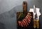 Slices of medium rare beef steak on wooden board, vintage carving cutlery