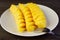 Slices of mouthwatering fresh ripe pineapple in white plate