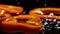 Slices of orandge bell pepper fall down on brown wooden board with water drops