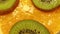 Slices of orange, kiwi top view. Slices of fruits are spinning. Fruit whirling