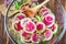 Slices pink fresh watermelon radish onion and celery homemade carpaccio salad for delicious breakfast on wooden table selective fo