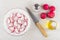 Slices of radish in bowl, knife, oil, salt on table