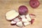 Slices of red potatoes on brown background