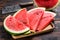 Slices of red striped watermelon. Dark Wooden background. Top view