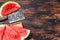 Slices of red striped watermelon. Dark Wooden background. Top view. Copy space