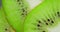 Slices of ripe kiwi under water with air bubbles. Macro background.