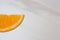 Slices of ripe orange closeup with drops of juice on a white background
