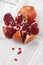 Slices of ripe pomegranate fruit on homemade table napkin