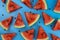 Slices of ripe watermelon on a blue background, texture, patern