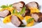 Slices of roasted duck meat fillet with orange and basil