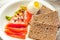 Slices of Salted Raw fish fillet with egg and piece of buckwheat gluten-free bread.  Paleo diet meal. Healthy high protein and low