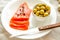 Slices of Salted Raw fish fillet with olive, quail eggs on white plate. Products good for healthy hair. Selective focus