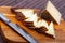 Slices of semi-hard spanish sheep cheese on desk