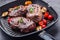 Slices of sirloin beef steak on meat fork on concrete background