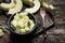 Slices and small pieces in a bowl of ivory gaya melon on a wooden background