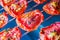 Slices of sun-dried tomatoes with spices on a metal wire rack in the oven. Close-up. Macro