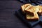 Slices toast wheat bread on a dark wooden background. Copy space.