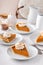 Slices of traditional pumpkin pie in a light and bright setting