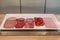 Slices various type of meat, sausage, salami and hams on white tray