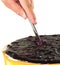 Slicing a blue berry cheese cake 1